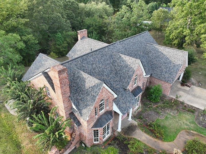 Completed residential shingle roof — aerial view showing clean ridge lines