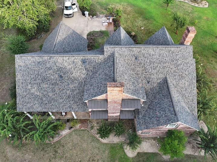 Clean shingle pattern on completed residential roof — drone shot