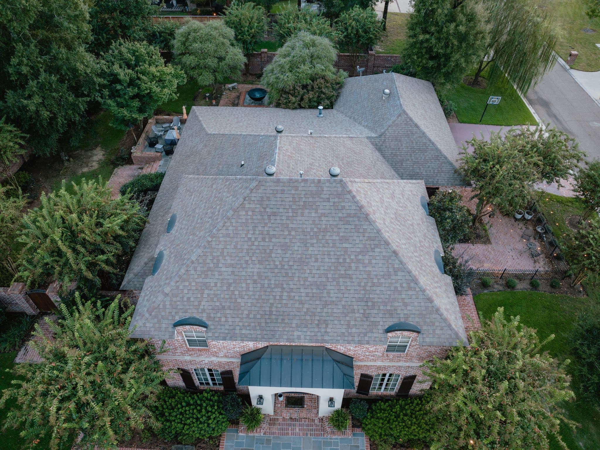 Jake Lilly Roofing crew installing shingles on residential roof